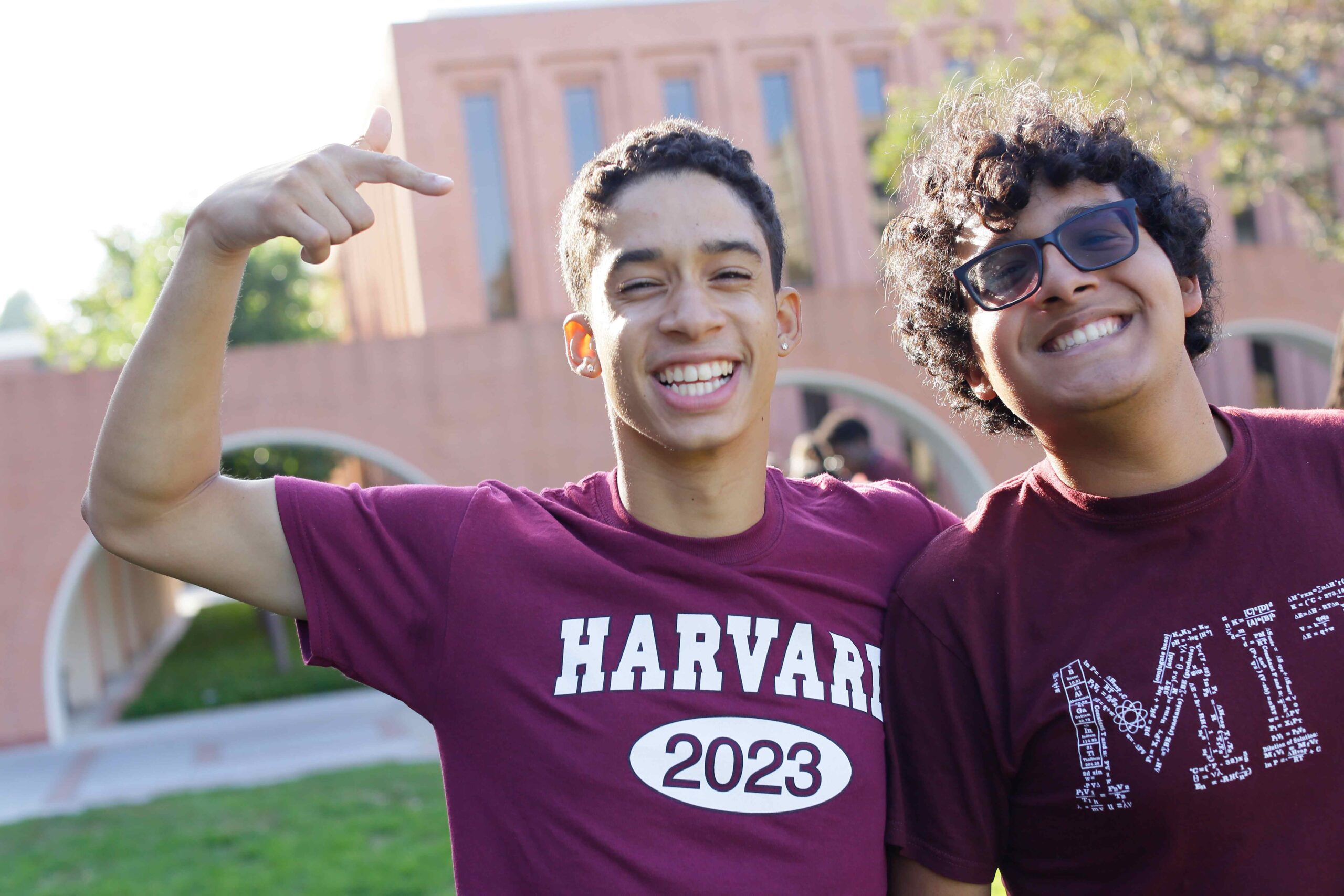 Two happy students with college shirts