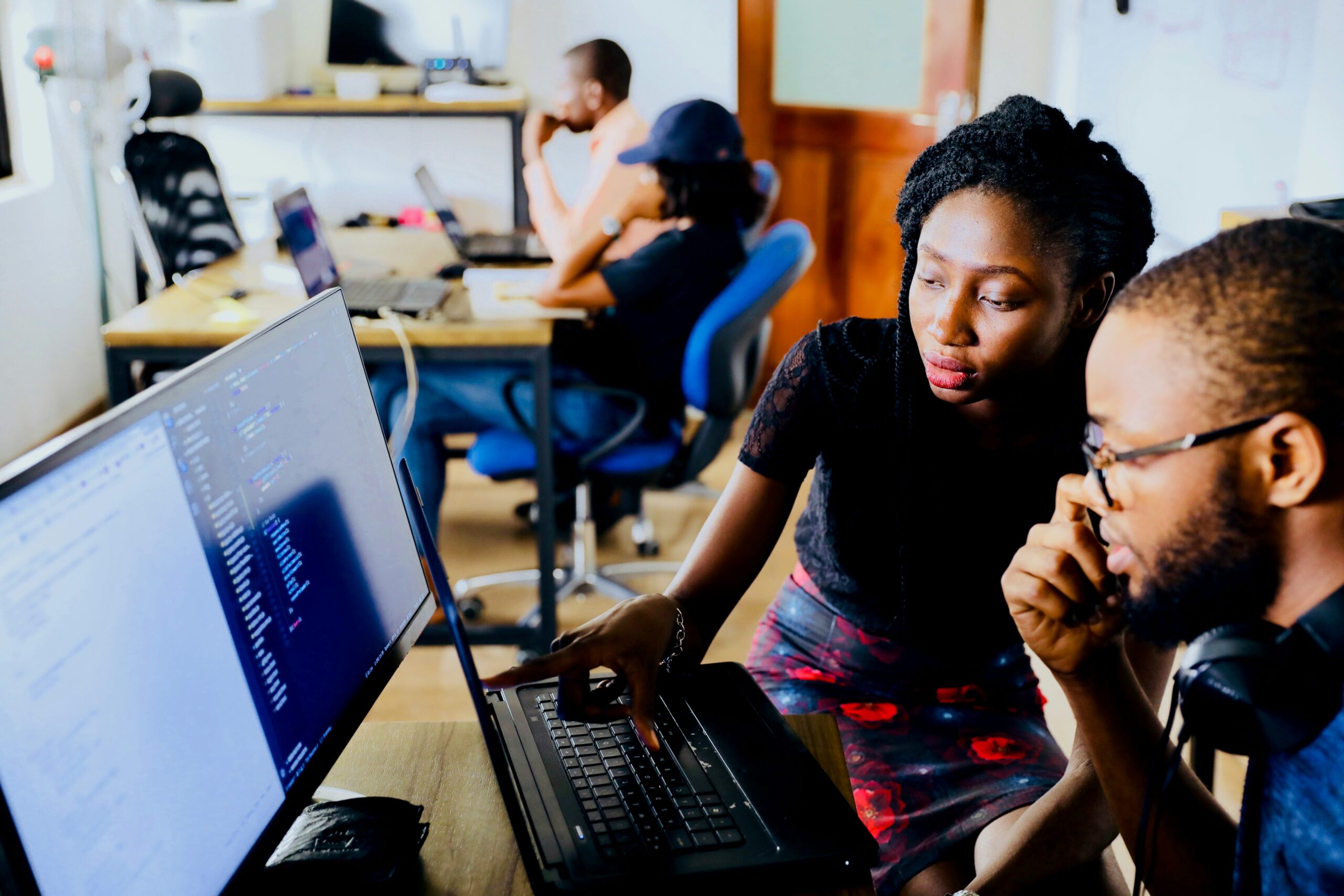 Black male and female students studying at computer